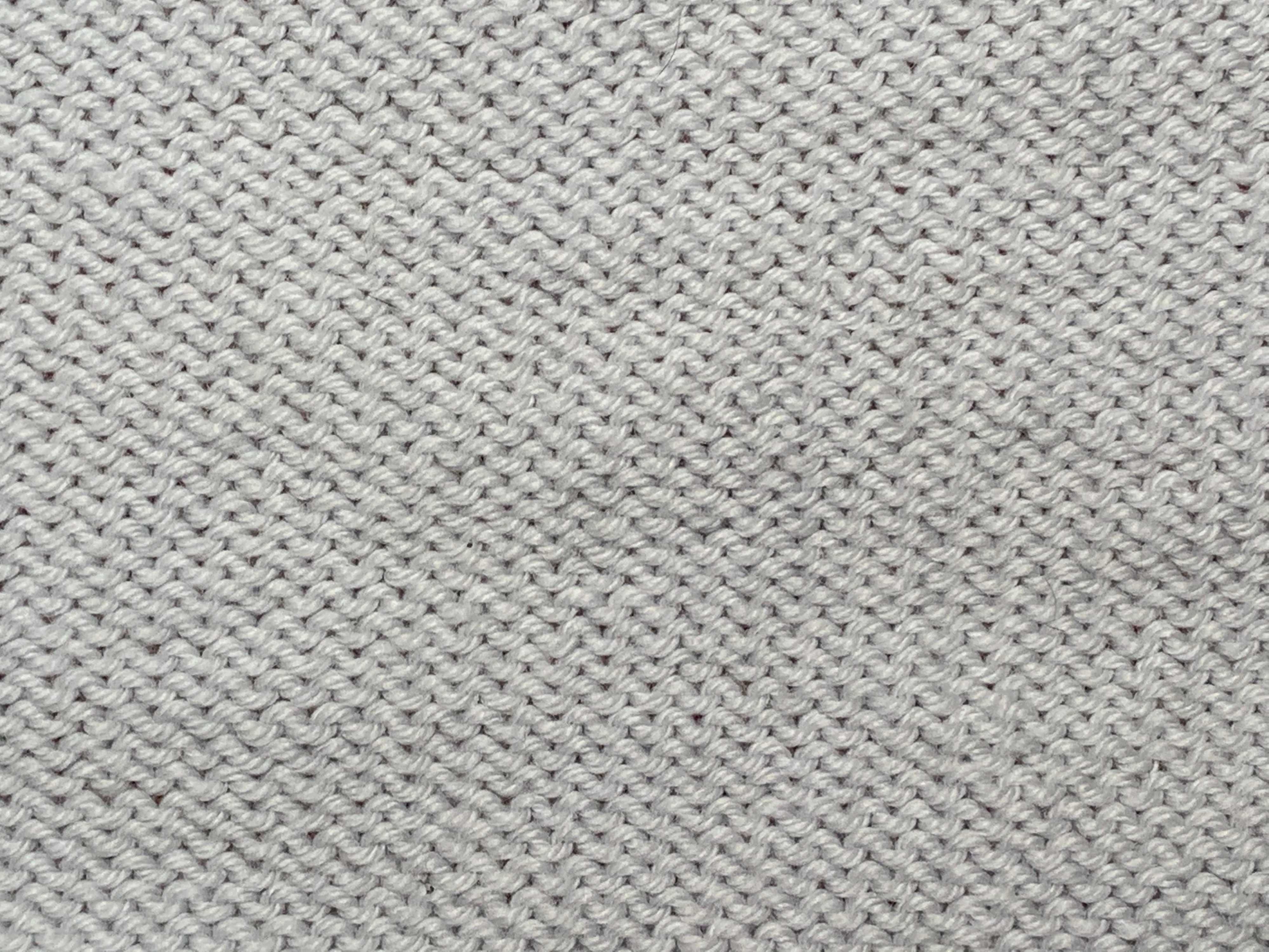 The right side of reverse stockinette, characterized by rows of purl bumps