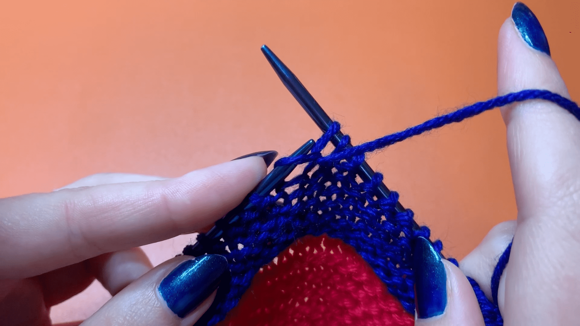 Step three of the English purl stitch